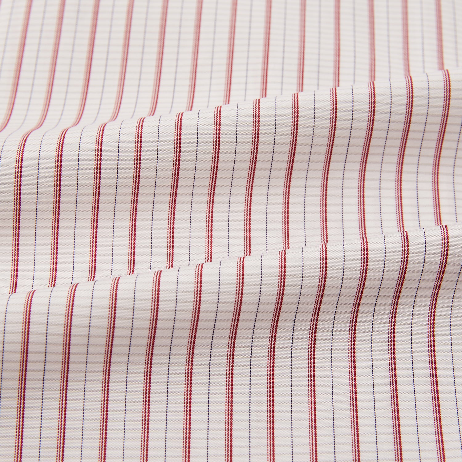 View 6 of product The Turnbull & Asser Red Graph Check Mayfair Shirt features a classic collar and buttoned cuffs, with red and blue stripes on white, ideal for formal wear. Laid flat on a white surface.