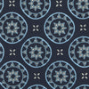View 4 of product The Jacquard Silk Geometric Tie by Turnbull & Asser features a navy blue base with light blue and white star and circle motifs, shown rolled on a white background.