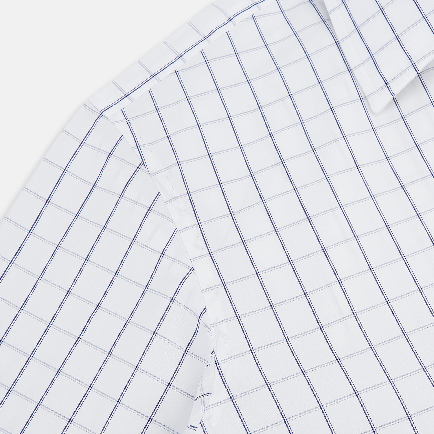 View 6 of product A Dark Navy Double-Line Checked Westminster Shirt by Turnbull & Asser, featuring button-down front, pointed collar, and buttoned cuffs—displaying British craftsmanship—laid flat on a white background.