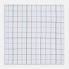 View 1 of product The Turnbull & Asser Hand Rolled Blue Grid Check Handkerchief features a classic blue and black grid on white cotton, neatly folded—a timeless gentleman's accessory.