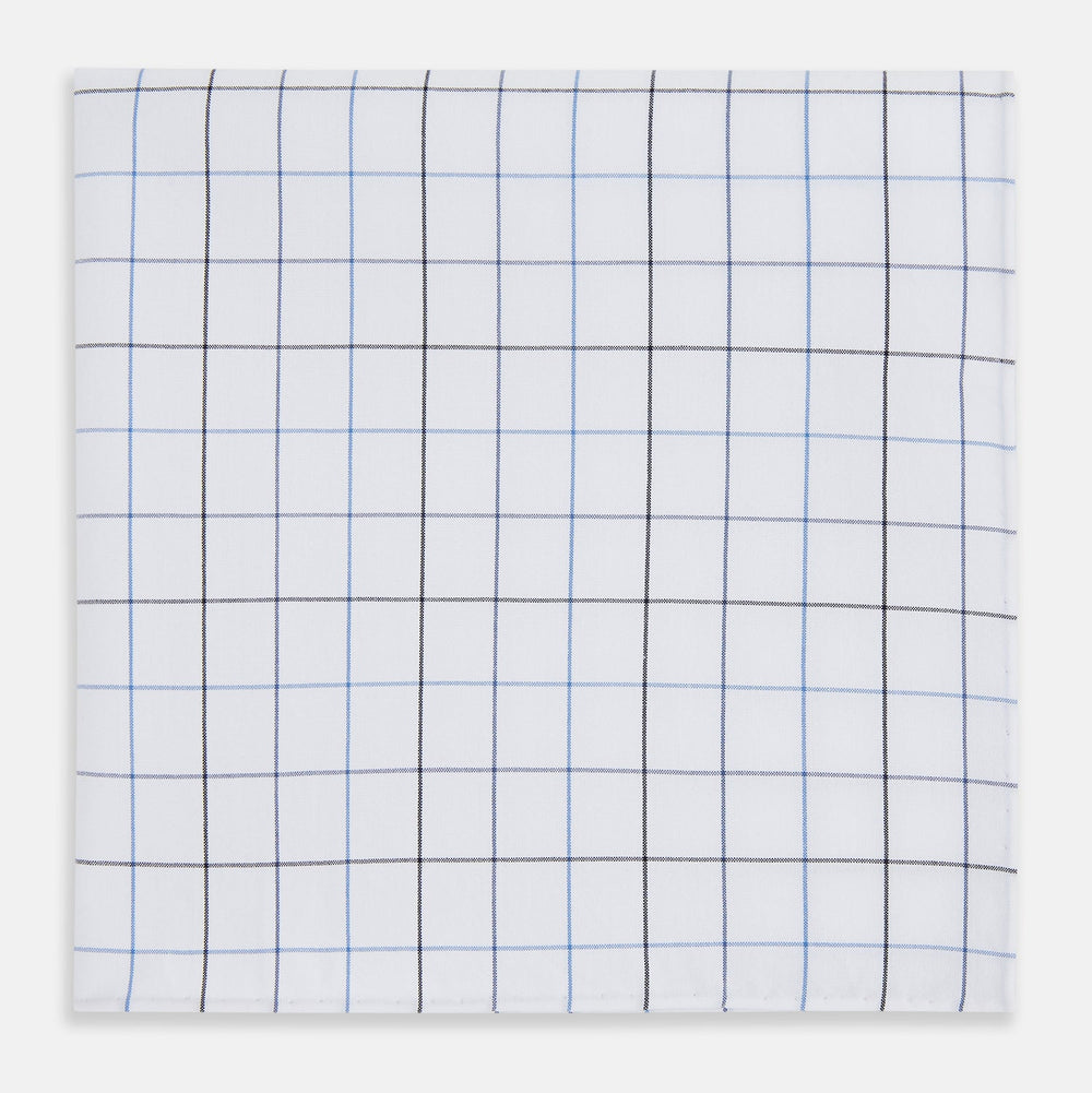 The Turnbull & Asser Hand Rolled Blue Grid Check Handkerchief features a classic blue and black grid on white cotton, neatly folded—a timeless gentleman's accessory.