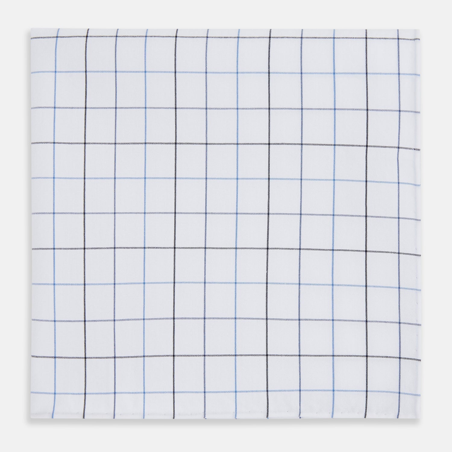 View 1 of product The Turnbull & Asser Hand Rolled Blue Grid Check Handkerchief features a classic blue and black grid on white cotton, neatly folded—a timeless gentleman's accessory.