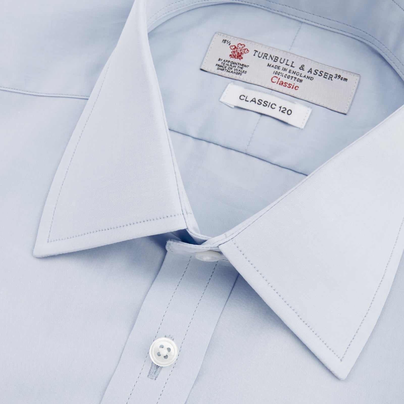 View 2 of product The Turnbull & Asser Two-Fold 120 Light Blue Shirt features a T&A collar, 3-button cuffs, white buttons, front pocket, and inner collar label. It is displayed neatly folded on a plain white background.