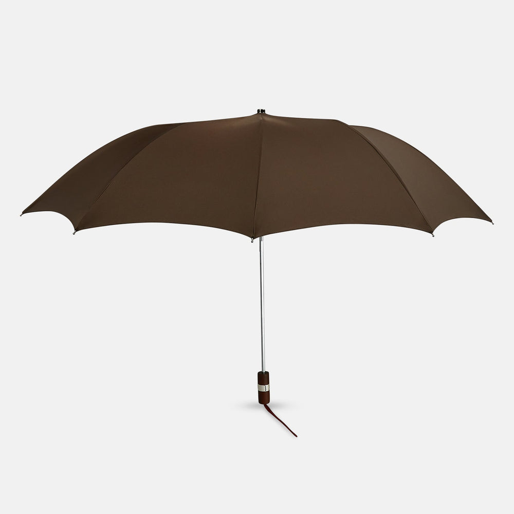 The Turnbull & Asser Brown Telescopic Umbrella features a brown maple handle and silver metal shaft—an elegant choice for men.