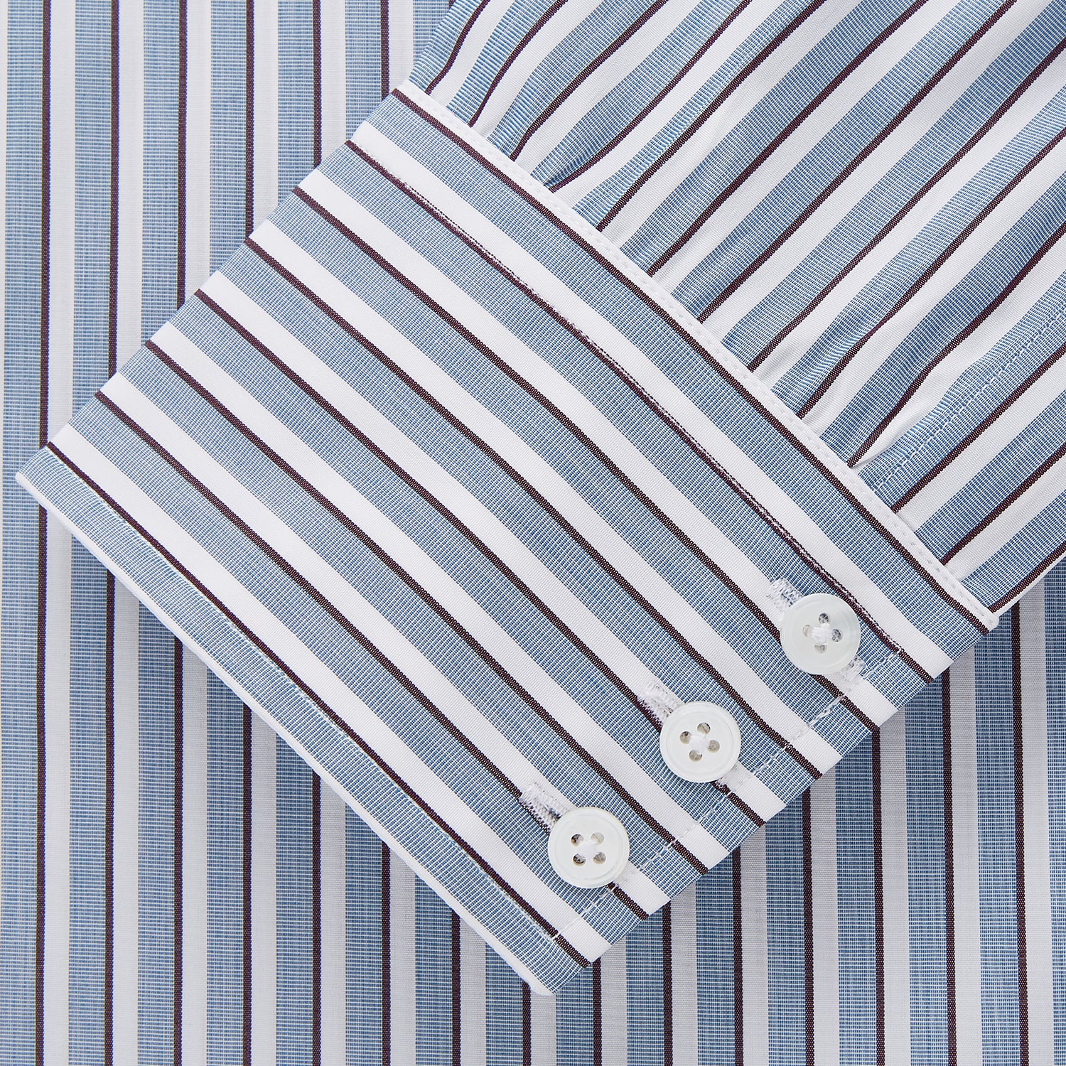 View 4 of product The Turnbull & Asser Blue and White Stripe Cotton Regular Fit Mayfair Shirt features long sleeves, a button-up front, collar, buttoned cuffs, and vertical stripes, shown on a white background.
