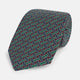 The Forest Green and Red Weave Patterned Silk Tie by Turnbull & Asser features a geometric interlocking design in red, blue, and green, elegantly rolled on a white background.