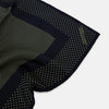 View 2 of product The Turnbull & Asser Navy and Gold Silk Pocket Square is handmade, featuring small gold polka dots on navy with a solid border, displayed neatly folded with one corner turned up.