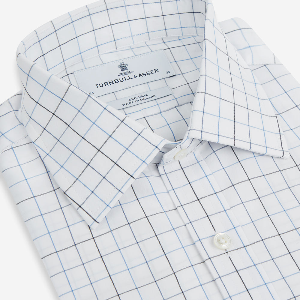 The Blue Grid Check Mayfair Shirt by Turnbull & Asser is a long-sleeve, button-up shirt with a T&A collar, crafted from organic cotton in a light and dark blue grid pattern, shown flat against a white background.