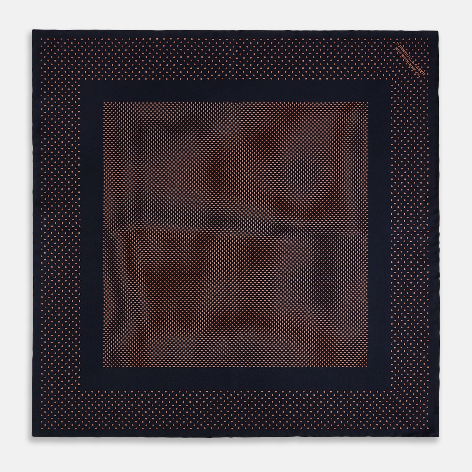 View 3 of product The Navy and Blush Dot Silk Pocket Square by Turnbull & Asser features a navy base with small orange polka dots and a border, shown neatly folded with one corner flipped over.