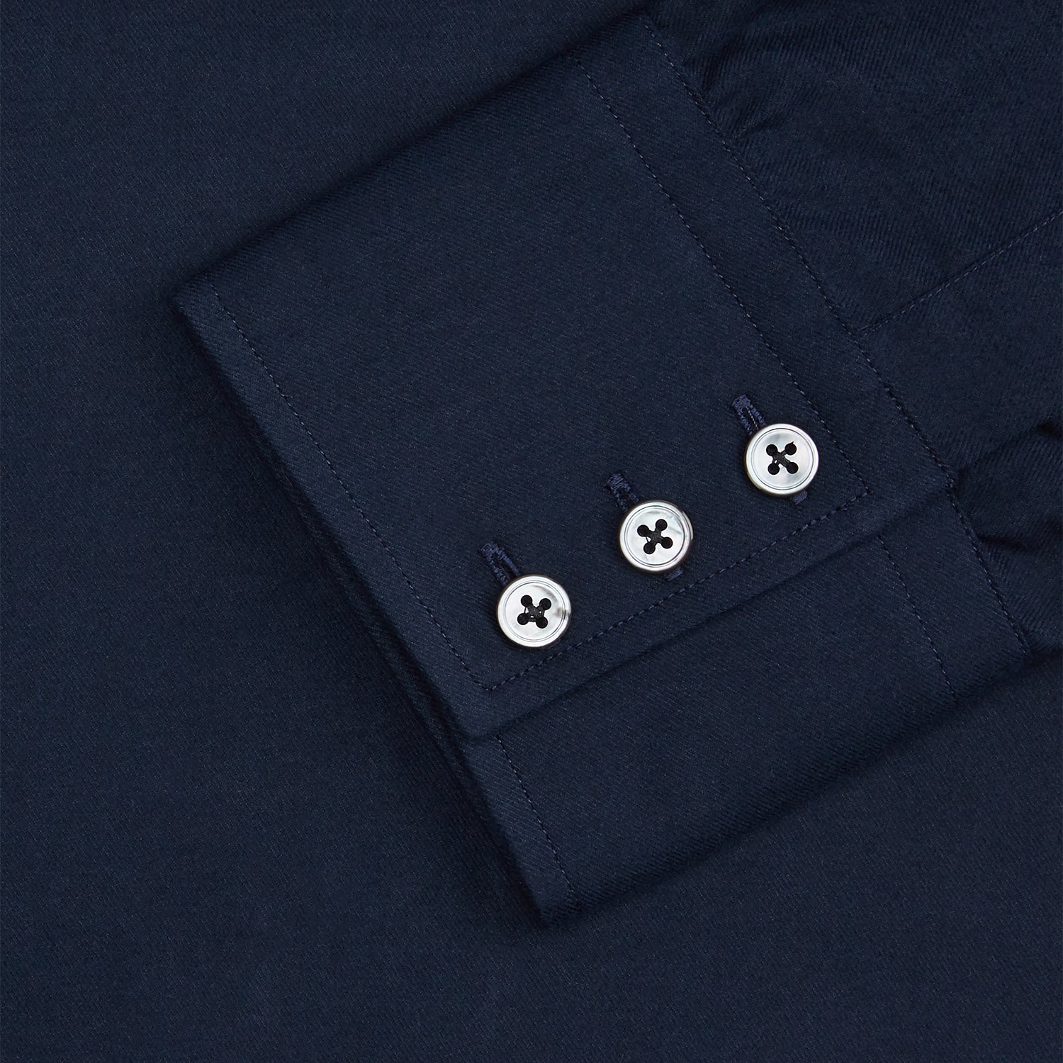 View 2 of product The Turnbull & Asser Navy Cotton Regular Fit Mayfair Shirt is a long-sleeved men’s formal shirt with a collar and white buttons, shown against a plain white background.