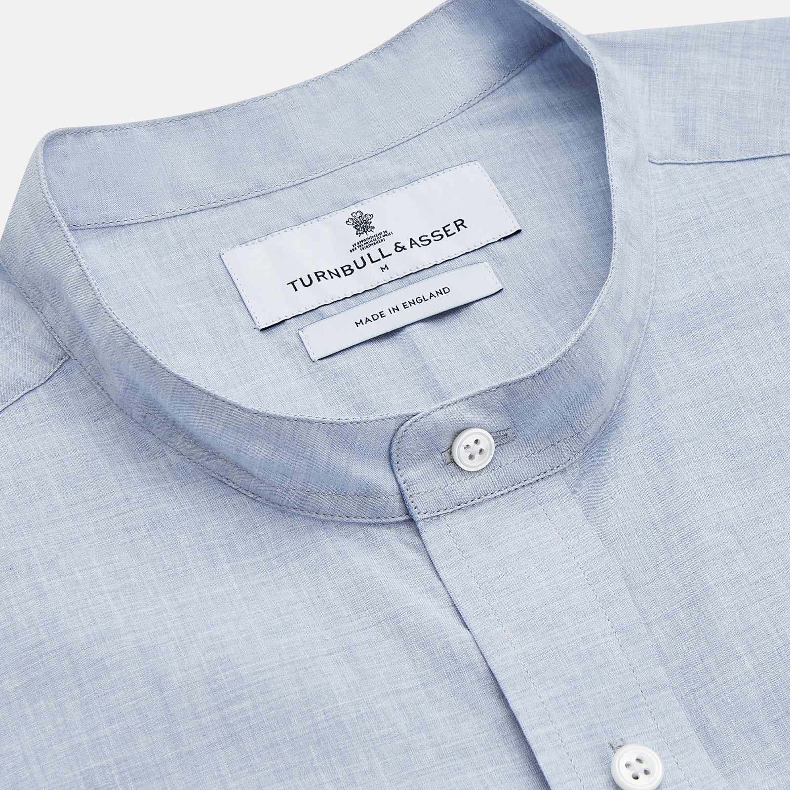 View 2 of product Turnbull & Asser’s Pale Blue Linen Blend Weekend Fit Unwin Shirt features long sleeves, a band collar, two chest pockets, and white buttons—ideal for casual summer wear.