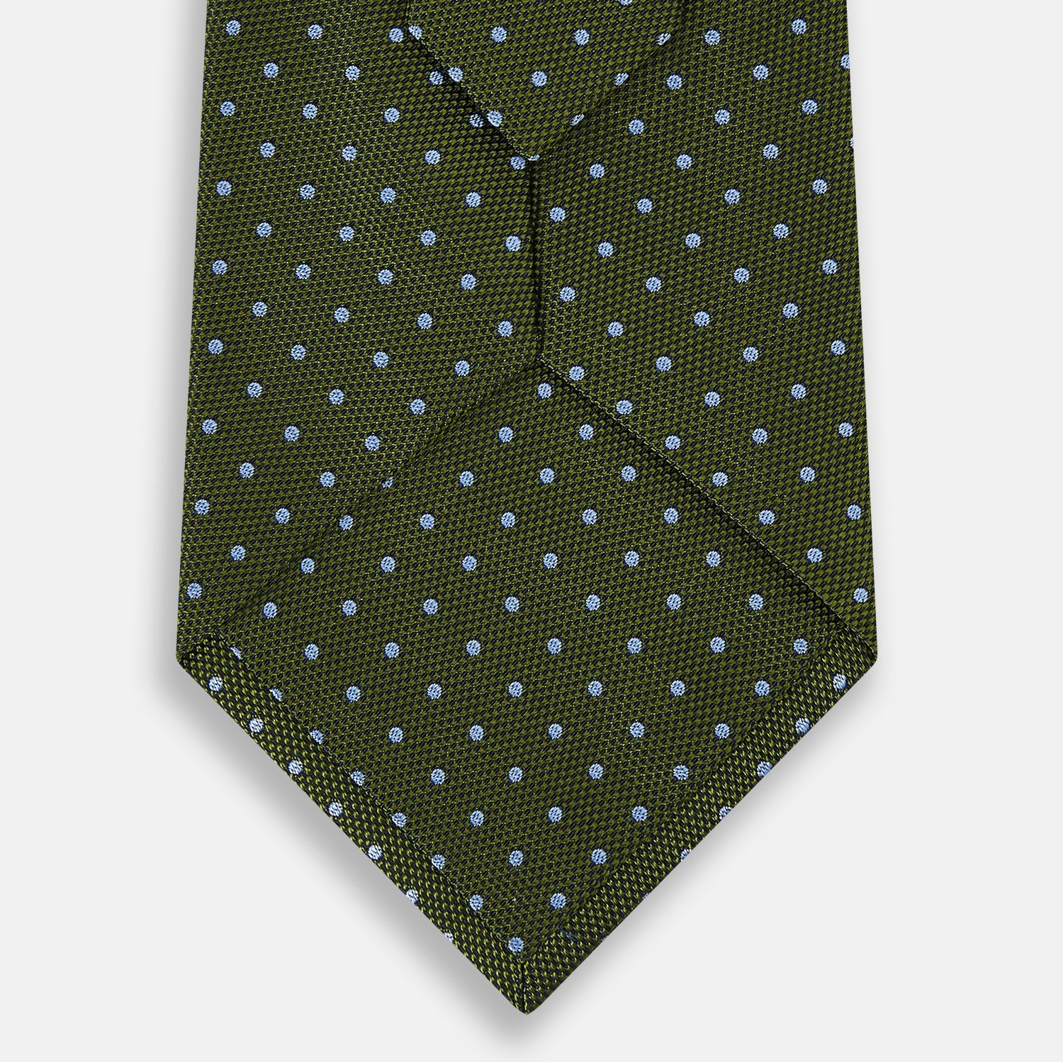 View 8 of product The Turnbull & Asser Green and Blue Micro Dot Silk Tie is shown rolled up, displaying small light blue dots on green silk against a plain white background.
