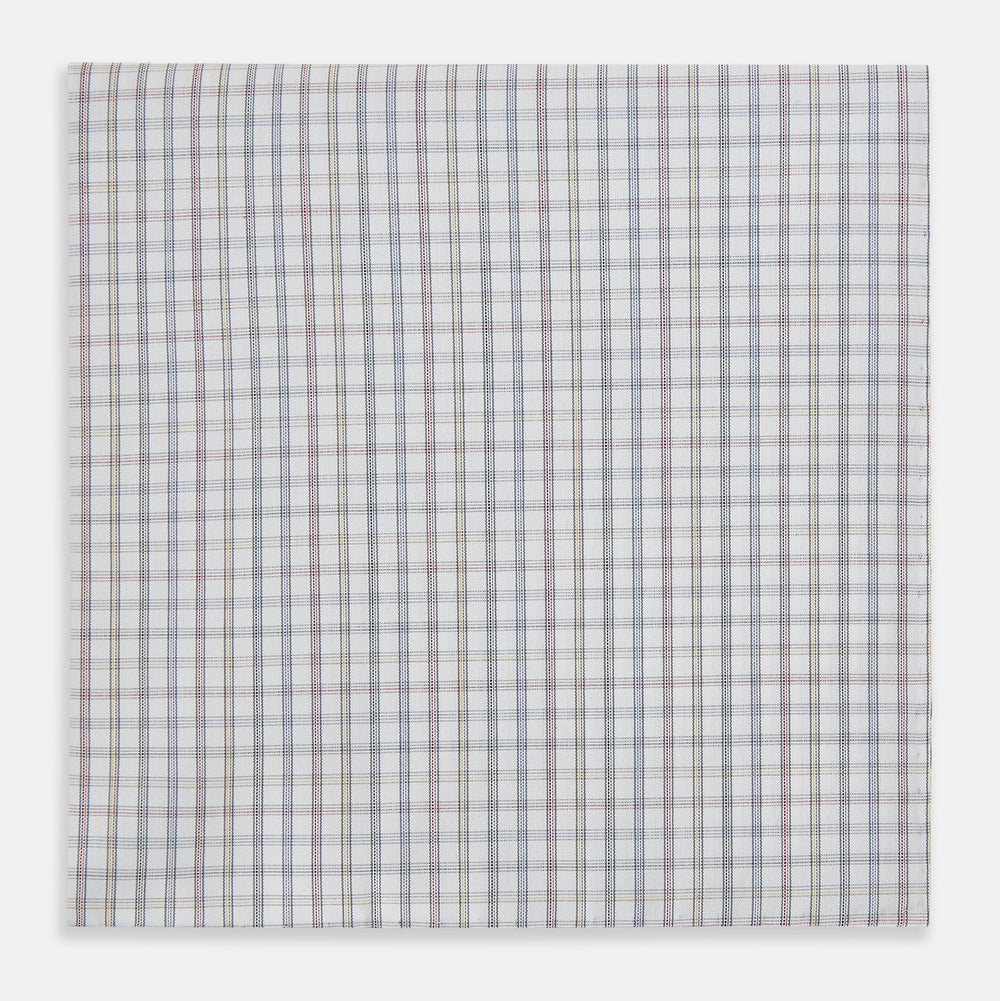The Sky Blue Multi Graph Check Hand-Rolled Handkerchief by Turnbull & Asser features thin blue, red, and beige lines forming small squares on white fabric. Crafted in England.