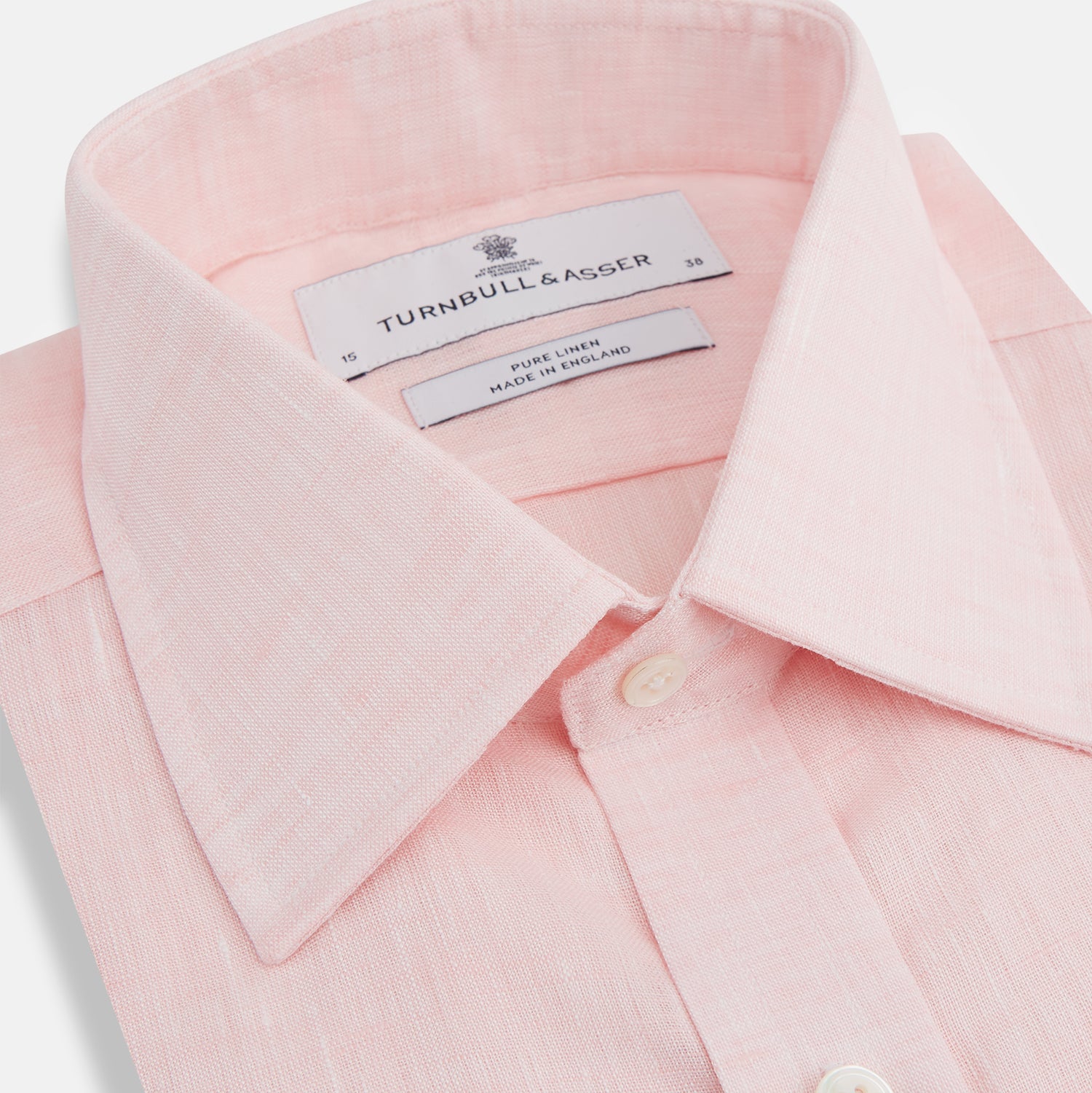 View 2 of product The Turnbull & Asser Pink Linen Shirt features a T&A collar, 3-button cuffs, and classic white buttons. This long-sleeved summer staple is shown on a plain white background.