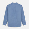 View 5 of product The Turnbull & Asser Blue Cotton Weekend Fit Blake Shirt features a light blue color, long sleeves, stand collar, white buttons, and a curved hem—ideal for casual weekends. Laid flat on a white background.