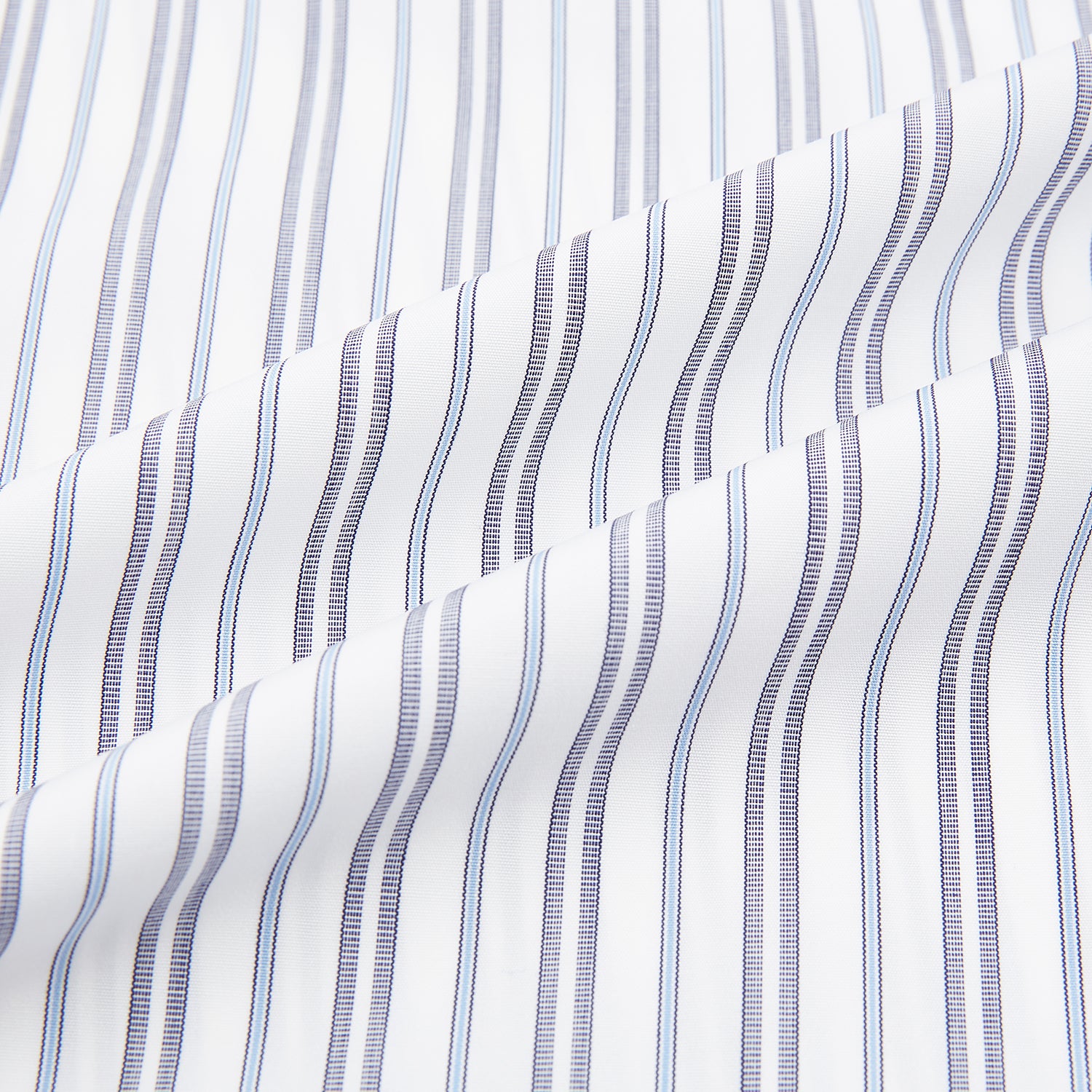 View 6 of product The Turnbull & Asser Navy Multi Stripe Mayfair Shirt features a T&A collar and premium Italian cotton, with vertical blue and white stripes. It is shown neatly laid flat on a white background.