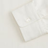 View 4 of product The Turnbull & Asser Cream Cotton Weekend Fit Unwin Shirt features long sleeves, a stand collar, and two chest pockets, shown laid flat on a white background.