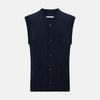 View 1 of product The Turnbull & Asser Navy Cashmere V-neck Sleeveless Cardigan features a button-up closure and two front pockets, ideal for elegant, gentleman-inspired looks, shown on a plain white background.