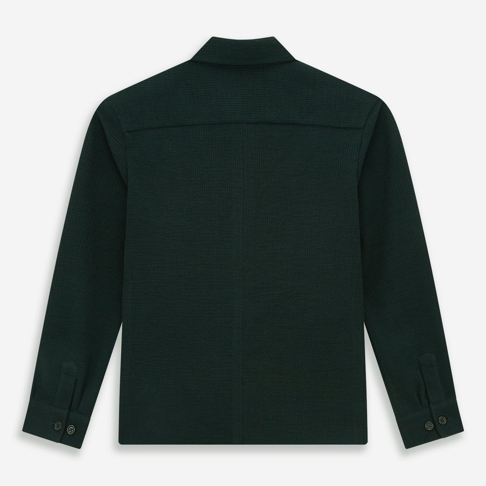 The Forest Green Greenwich Knitted Overshirt by Turnbull & Asser, crafted from Italian wool, features long sleeves, a collar, front buttons, and two chest pockets—one flap, one open—shown on a white background.