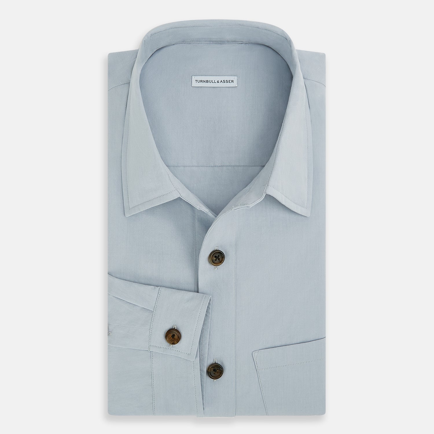 View 5 of product The Turnbull & Asser Grey Hyde Overshirt is a long-sleeve button-up made from sanforised cotton, featuring a single chest pocket and dark buttons, shown against a plain white background.