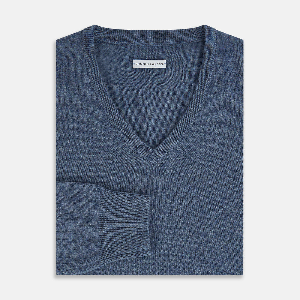 The Blue Melange Cashmere V-neck Jumper by Turnbull & Asser, featuring ribbed cuffs and hem, is part of our knitwear collection and shown against a white background.
