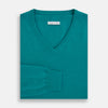 View 4 of product The Turnbull & Asser Turquoise Cashmere V-neck Jumper features long sleeves with ribbed cuffs and hem, displayed on a plain white background—a chic knitwear addition.