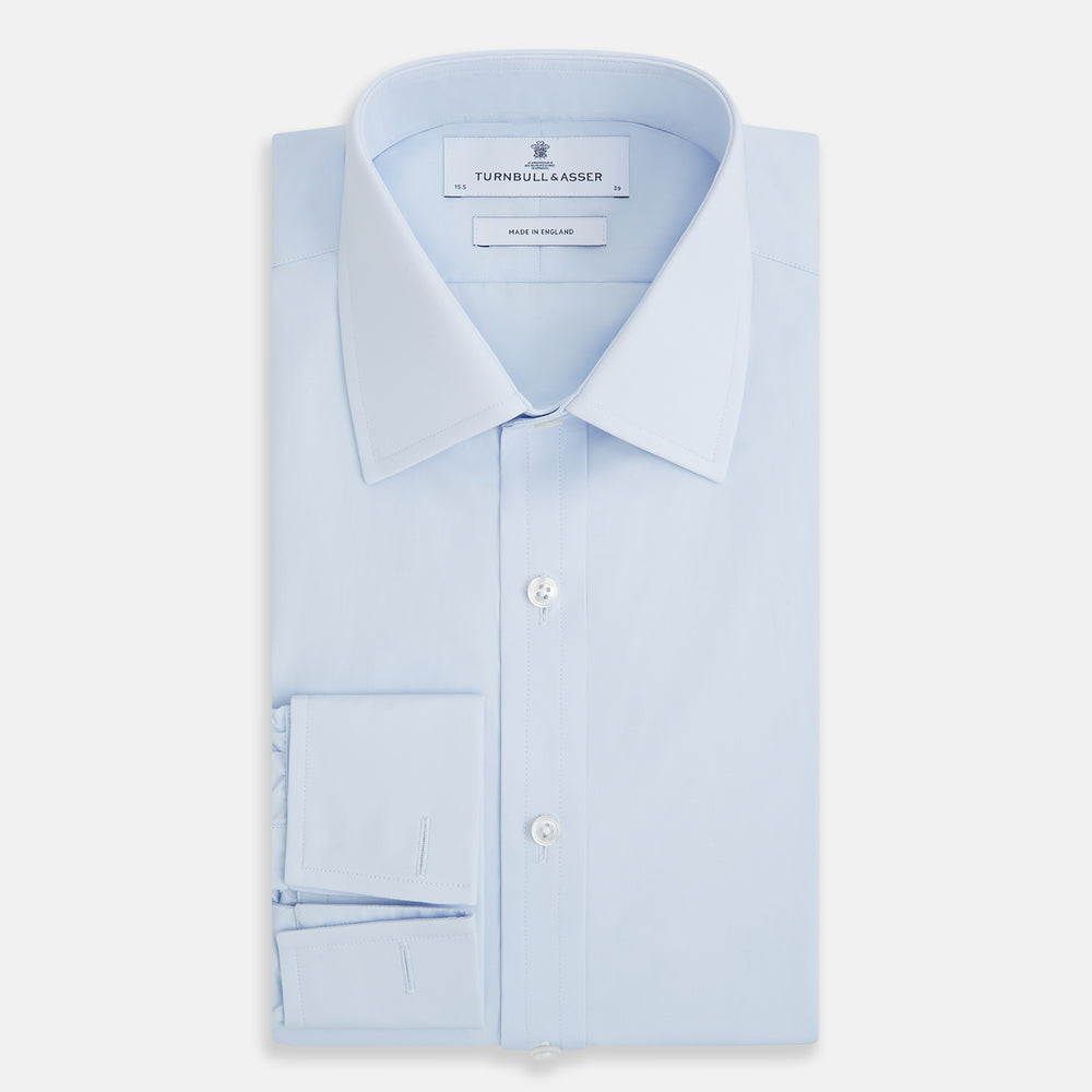 The Turnbull & Asser Light Blue Mayfair Shirt features white buttons, a classic collar, and buttoned cuffs—styled flat on a white background, it’s ideal for minimalist outfits or pairing with bold ties.