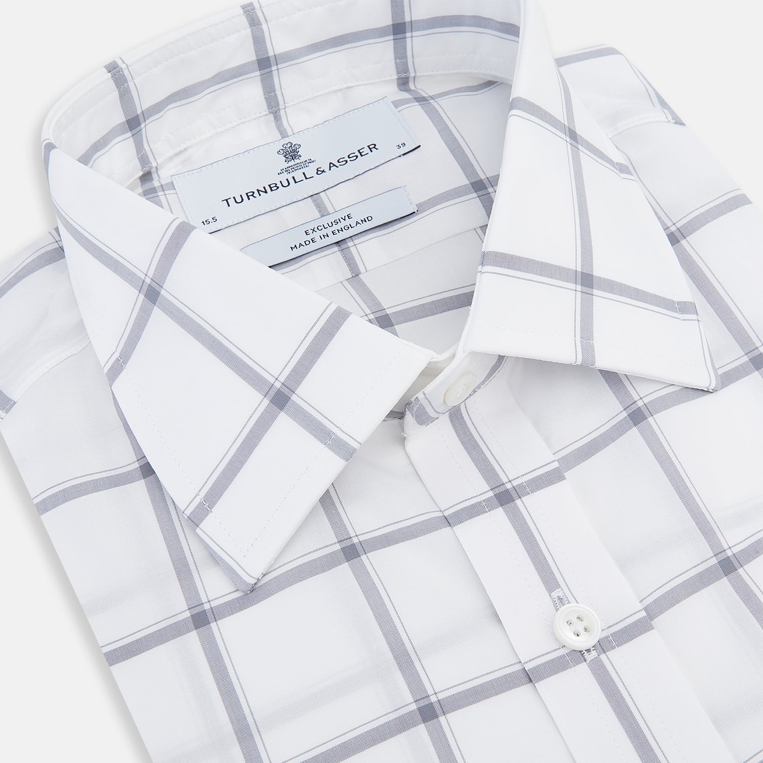 View 2 of product The Turnbull & Asser Grey Grid Check Mayfair Shirt features a classic collar and buttoned cuffs, crafted from fine Italian cotton with a grey grid check on white, and is shown against a plain white background.
