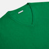 View 2 of product The Turnbull & Asser Grass Green Cashmere V-neck Jumper, with long sleeves, is displayed against a white background, highlighting its classic knitwear style.