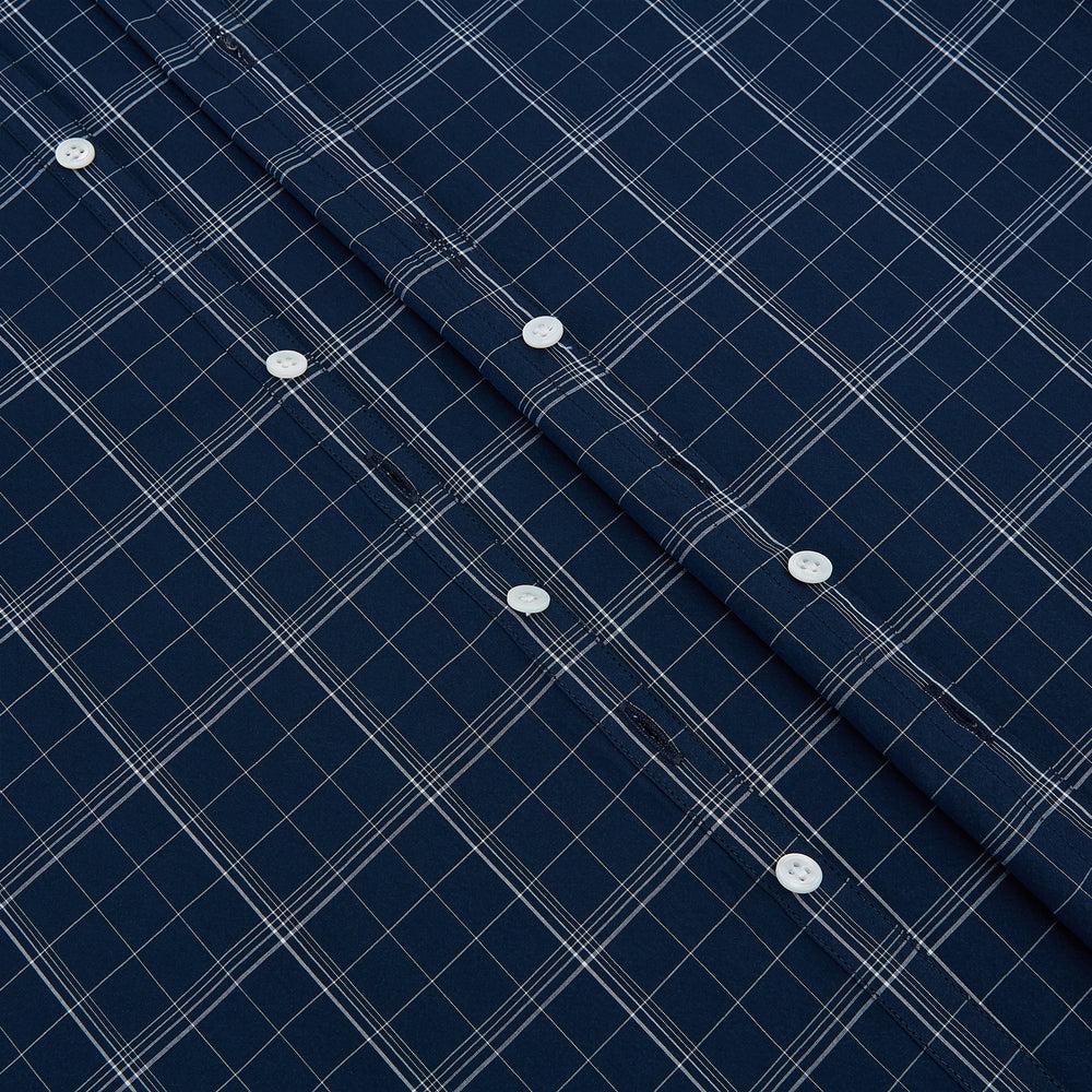 The Turnbull & Asser Indigo Windowpane Check Windsor Shirt features a contrast T&A collar and cuffs, highlighting British craftsmanship. It is displayed flat on a white background.