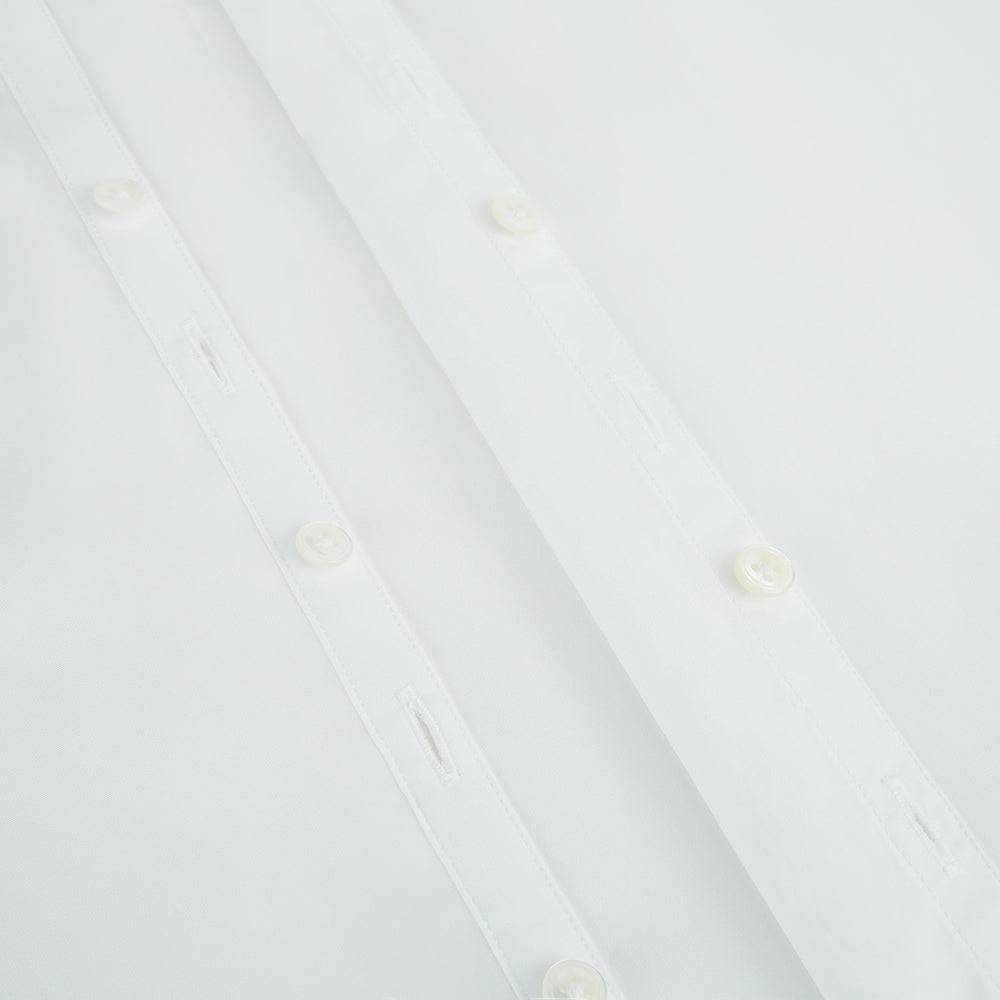 The PLAIN WHITE WESTMINSTER SHIRT WITH TURNBULL COLLAR AND 3-BUTTON CUFFS by Turnbull & Asser features refined British craftsmanship, long sleeves, a straight hem, and a crisp white design displayed on a plain background.