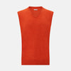 View 1 of product The Turnbull & Asser Red Orange Cashmere Sleeveless Vest with a V-neck, ribbed hem, and minimalist design is showcased against a white background—ideal for the refined gentleman.