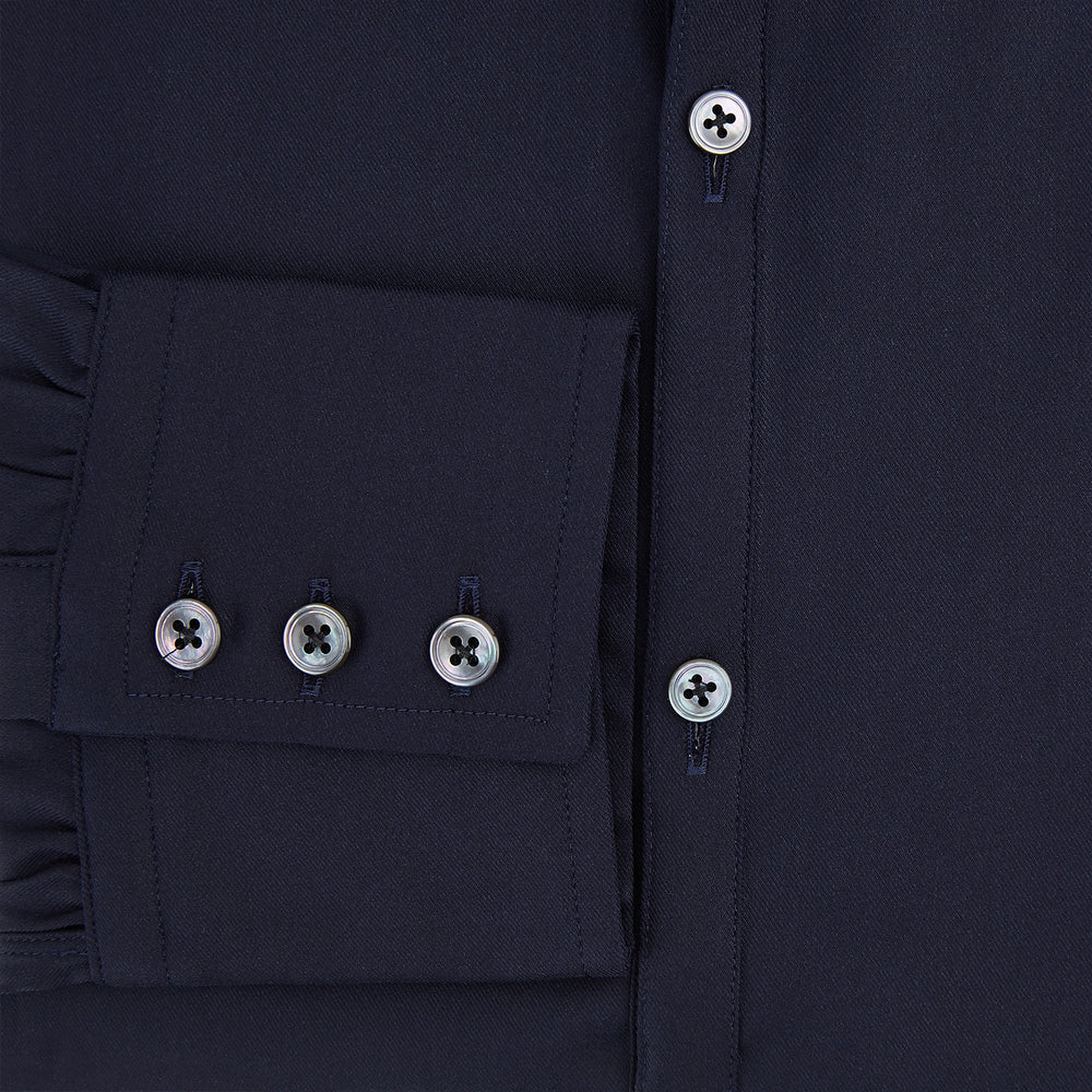 The Navy Twill Windsor Shirt by Turnbull & Asser features long sleeves, a button-up front, British craftsmanship, and a refined Windsor collar, shown in dark navy on a plain white background.
