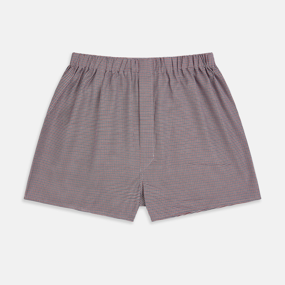 The Turnbull & Asser Burgundy Houndstooth Godfrey Boxer Shorts are luxury men's underwear made from Italian cotton, featuring an elastic waistband and a small maroon and white houndstooth pattern.