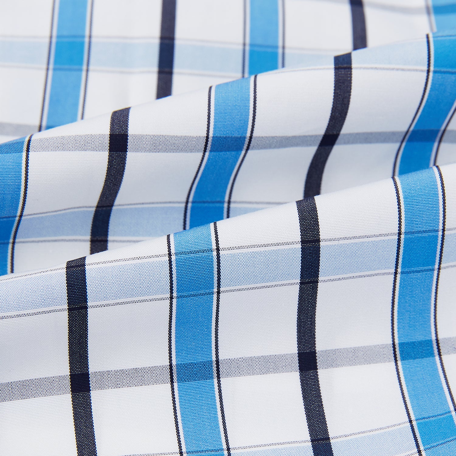 View 6 of product The Turnbull & Asser Blue and Navy Combination Check Mayfair Shirt features a classic button-up style with long sleeves, T&A collar, and a blue, navy, and white check pattern, shown against a plain white background.