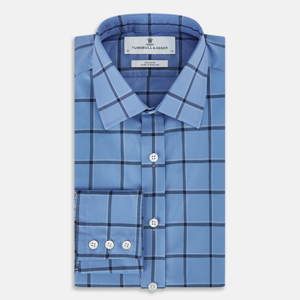 The Turnbull & Asser Colony Blue Grid Check Mayfair Shirt is a light blue, long-sleeve button-up with a collar and evenly spaced dark blue grid lines.