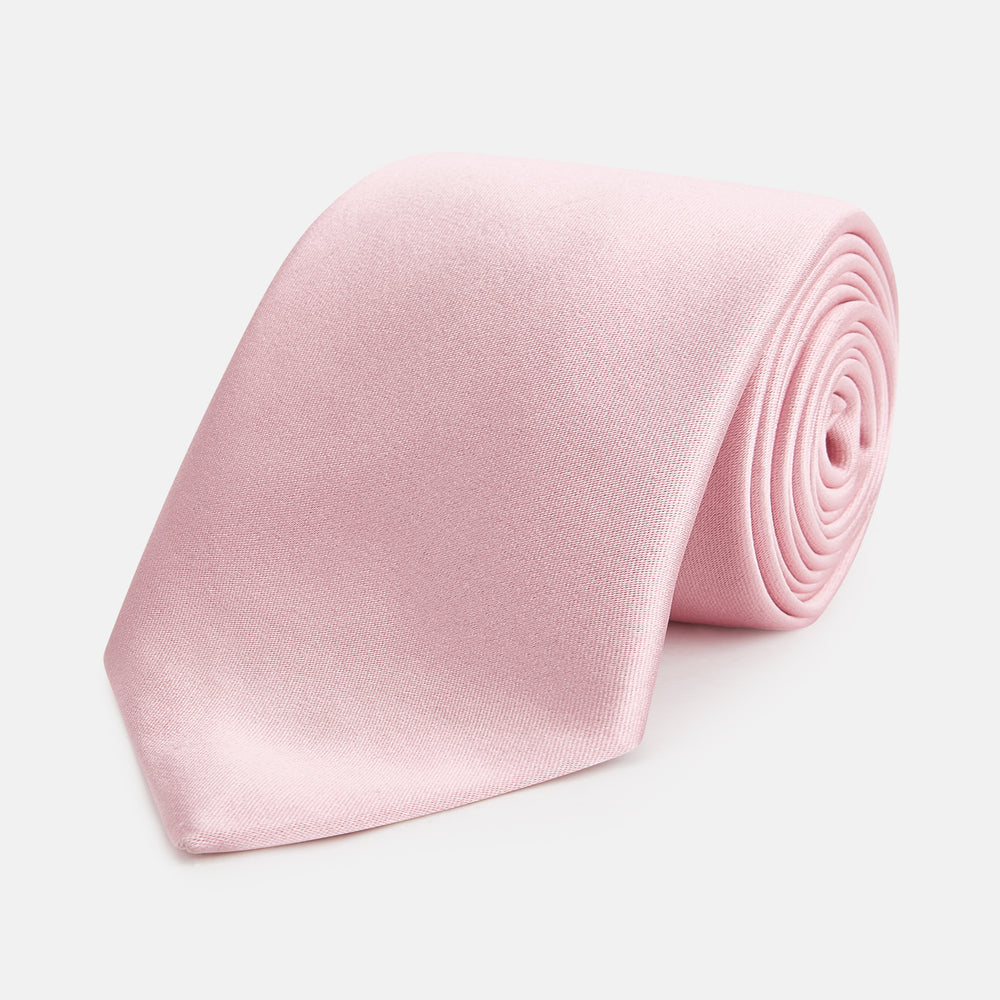 The Turnbull & Asser PINK PLAIN SATIN SILK TIE is neatly rolled and showcased against a plain white background.