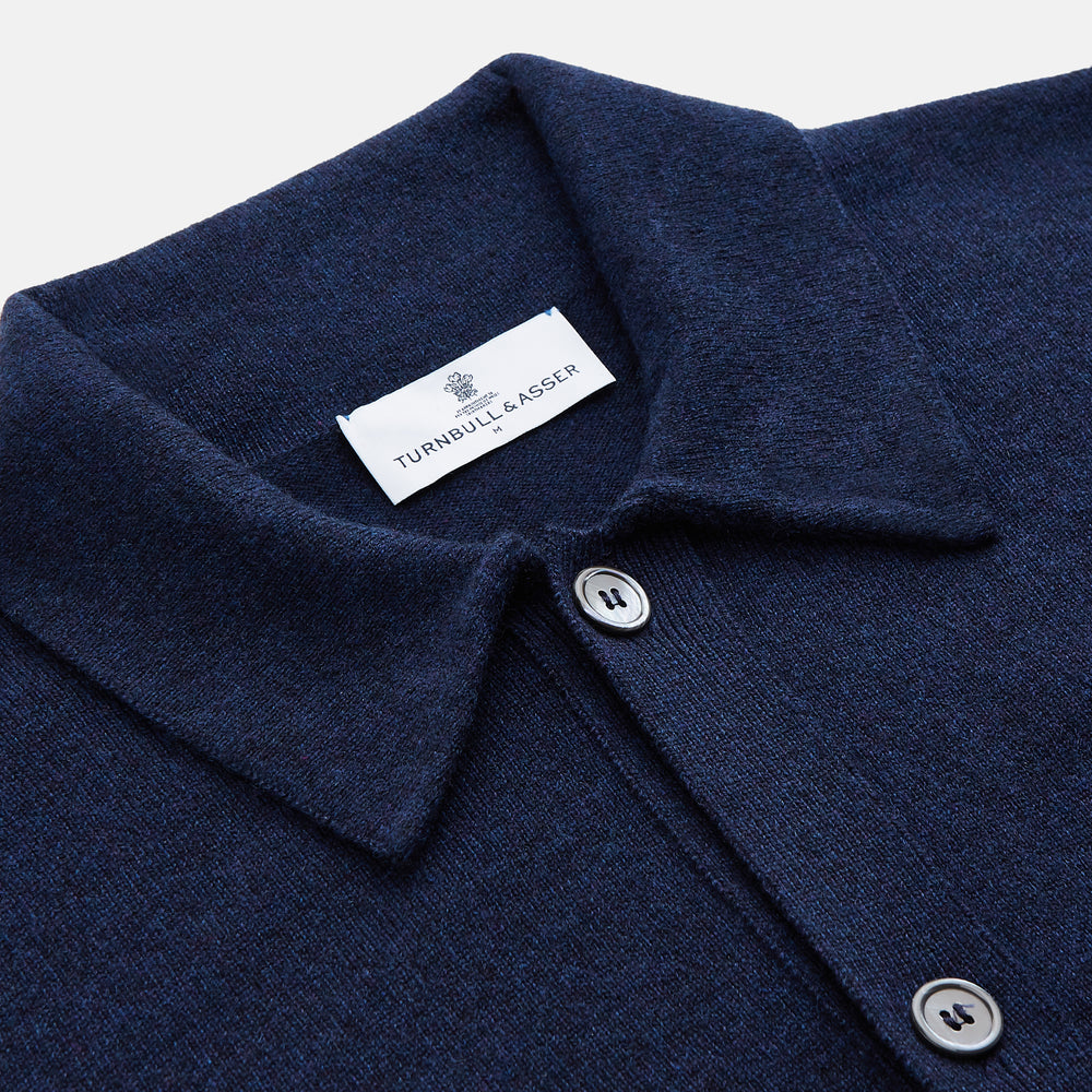 The Turnbull & Asser Navy Cashmere Duncan Knitted Shirt, a button-up with collar, long sleeves, chest pocket, and straight hem, is shown laid flat on a white background.