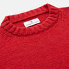 View 3 of product The Red Lewis Guernsey Knitted Jumper by Turnbull & Asser is a bright red wool-cotton, long-sleeve jumper with a round neckline, ribbed cuffs, and ribbed hem, shown against a white background.