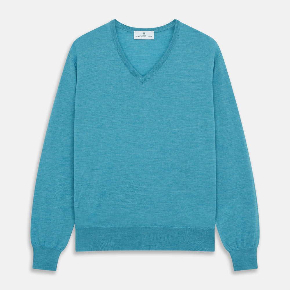 The Turquoise Kennedy Merino V-Neck Jumper by Turnbull & Asser features ribbed cuffs and hem, crafted from premium merino knitwear, and is shown flat on a white background.