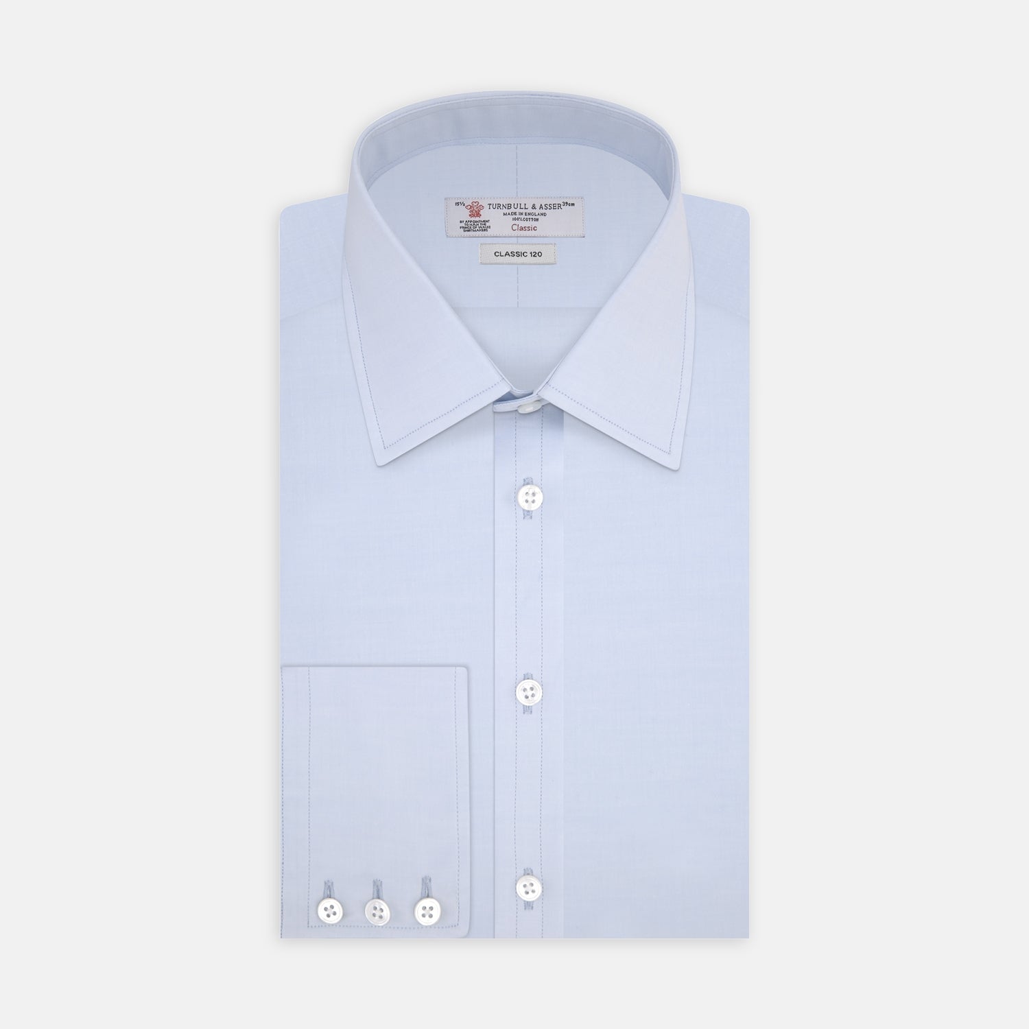 View 1 of product The Turnbull & Asser Two-Fold 120 Light Blue Shirt features a T&A collar, 3-button cuffs, white buttons, front pocket, and inner collar label. It is displayed neatly folded on a plain white background.