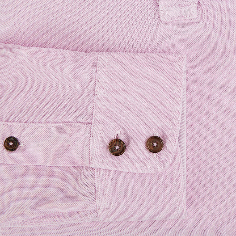 The Pink Rugby Polo Shirt by Turnbull & Asser features long sleeves, a collar, and V-neck opening in luxury cotton, shown flat on a white background.