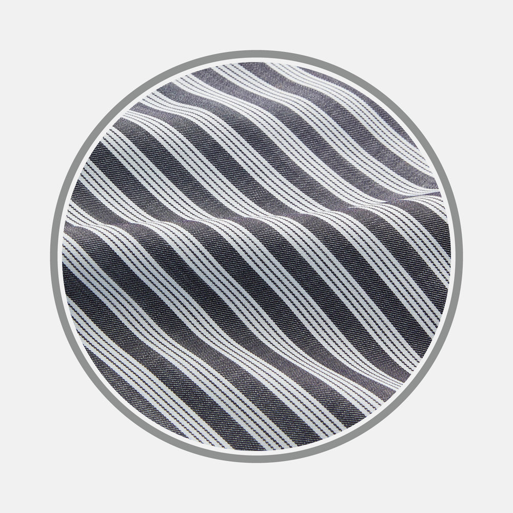 Close-up of Turnbull & Asser's Navy Multi Stripe Wool Fabric, featuring diagonal white stripes, displayed inside a circular frame on a light gray background.