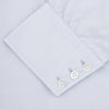View 3 of product The Turnbull & Asser Two-Fold 120 Light Blue Shirt features a T&A collar, 3-button cuffs, white buttons, front pocket, and inner collar label. It is displayed neatly folded on a plain white background.