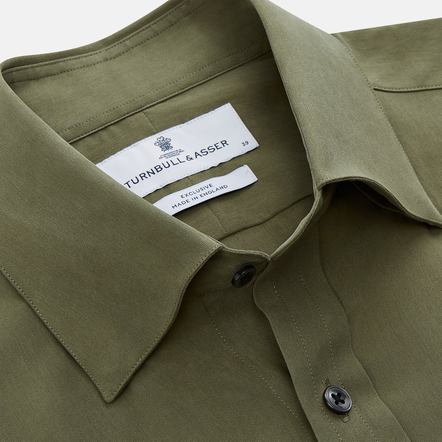 View 2 of product The Turnbull & Asser Green Silk Regular Fit Flaxton Shirt features long sleeves, a classic Bury collar, white buttons, and a straight hem, shown against a plain white background.
