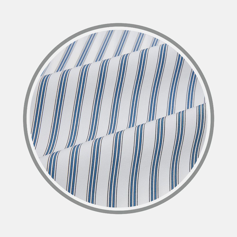 Close-up of Turnbull & Asser's Blue Multi Wide Track Stripe Fabric, featuring white fabric with evenly spaced vertical blue and black stripes, displayed in a circular frame on a light gray background.