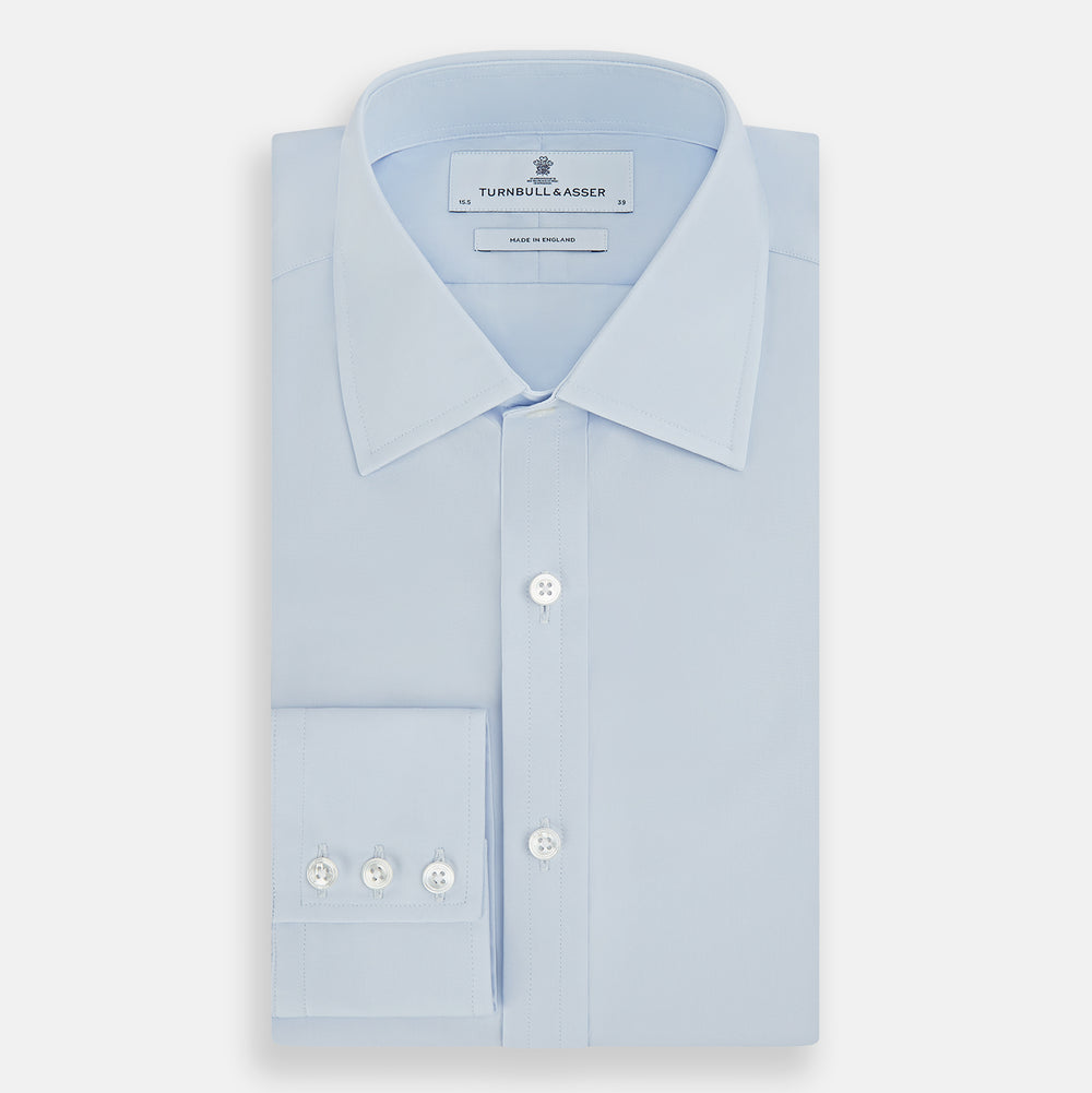 The Turnbull & Asser Pale Blue Cotton Regular Fit Mayfair Shirt features a classic collar, white buttons, and buttoned cuffs. This long-sleeve dress shirt displays the timeless Mayfair silhouette for a refined look.