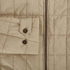 View 4 of product The Battersea Sand Quilted Jacket by Turnbull & Asser is a light beige men's jacket with a front zipper, pointed collar, zippered side pockets, chest pocket, and buttoned cuffs, shown on a plain white background.