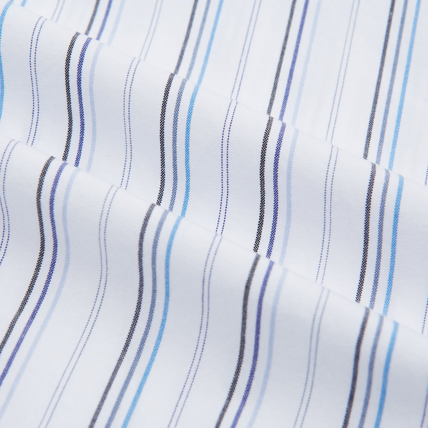 View 5 of product The Turnbull & Asser Blue Fine Multi Pinstripe Mayfair Shirt features long sleeves, an organic cotton build, a T&A collar, and vertical blue stripes. Laid neatly on a white background.