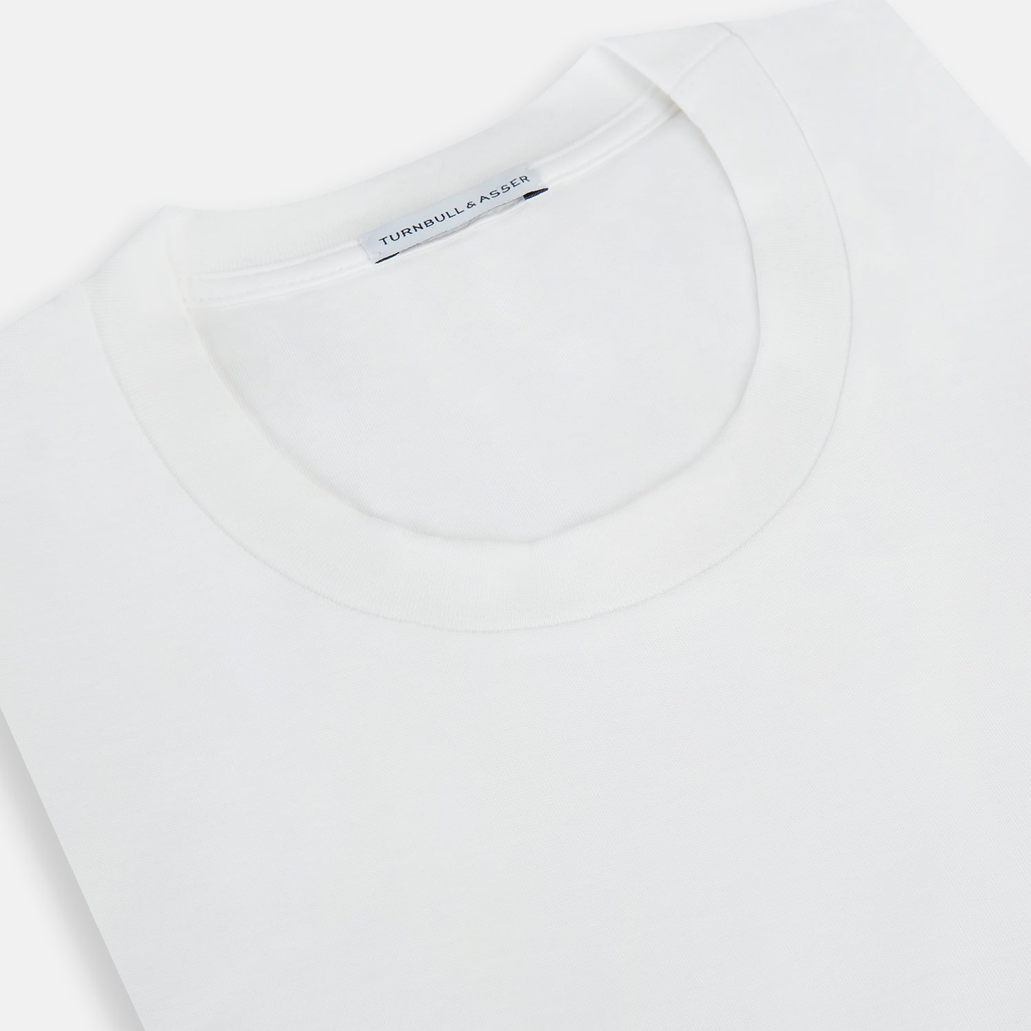 View 2 of product The Turnbull & Asser White Short-sleeve Fitted T-Shirt is a classic, logo-free crew neck laid flat on a white background—perfect for smart casual looks.